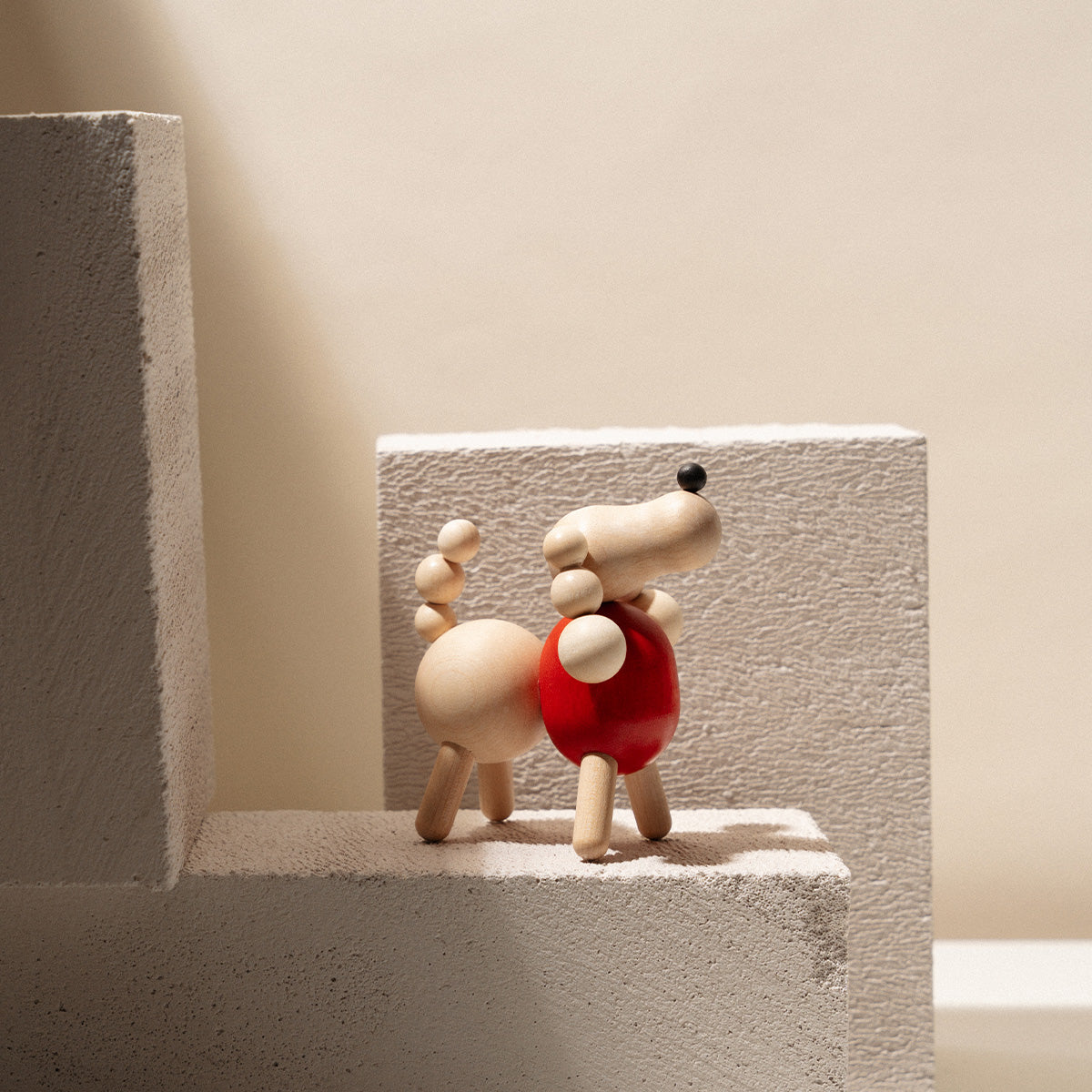 Poodle sculpture, varnished wood and red